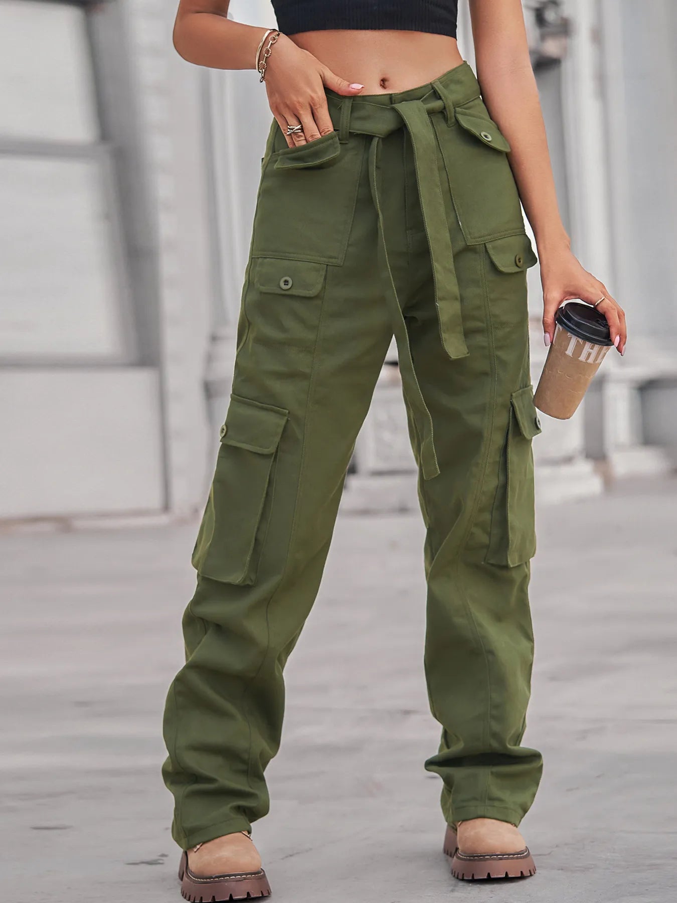 High-Waisted Multi-Pocket Cargo Jeans in olive green with a model holding a coffee cup, emphasizing stylish functionality.
