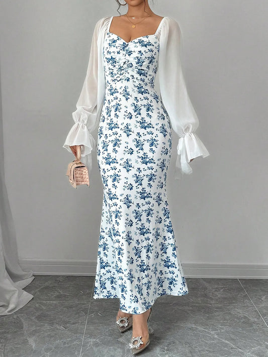 Floral Print Maxi Dress with Sweetheart Neckline and Ruffled Design, highlighting the elegant silhouette and sheer sleeves on a model.