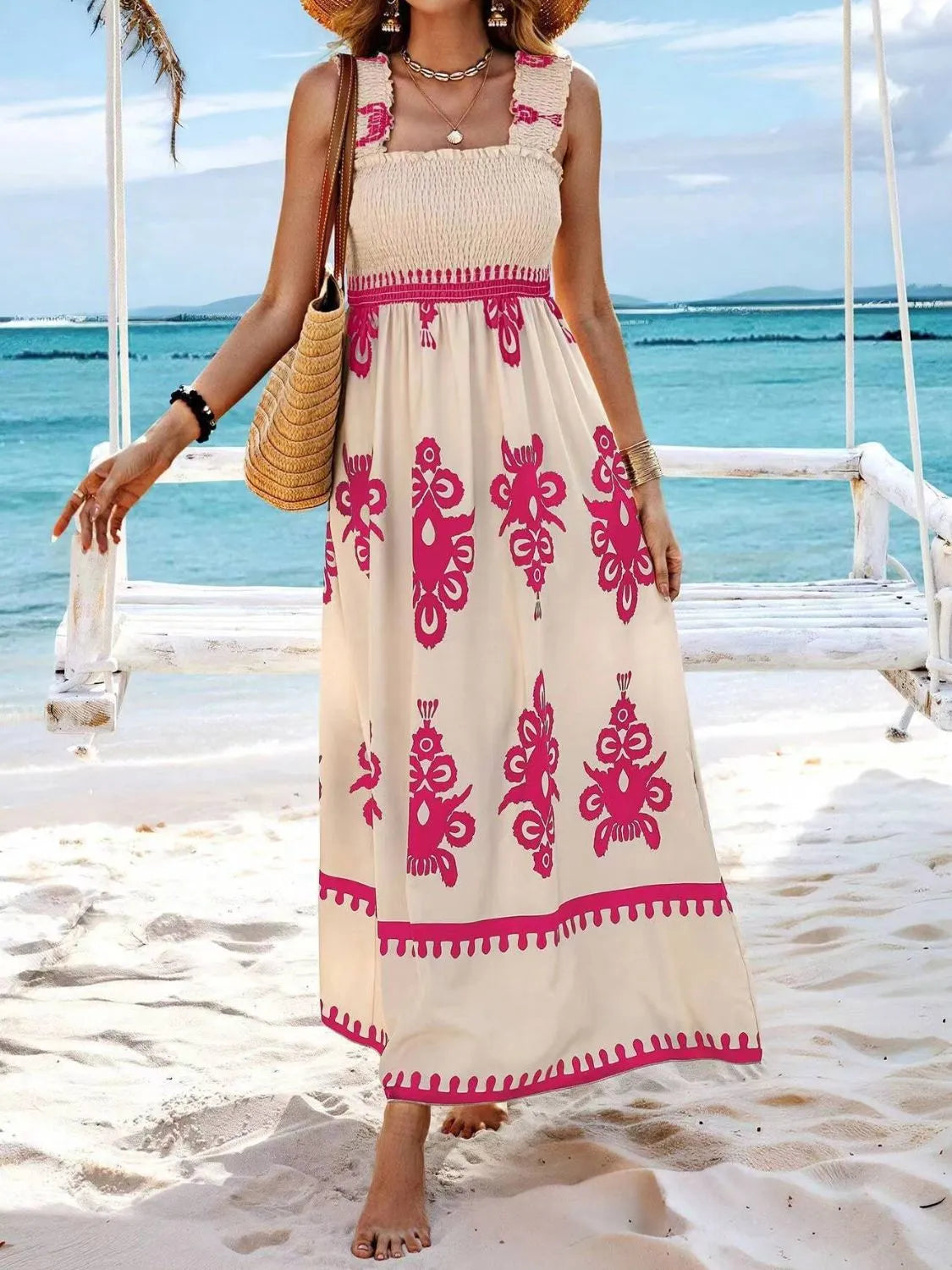 Trendsi Smocked Printed Maxi Dress with Wide Straps worn on the beach, featuring a lovely cream and pink design, perfect for casual seaside outings or summer events.