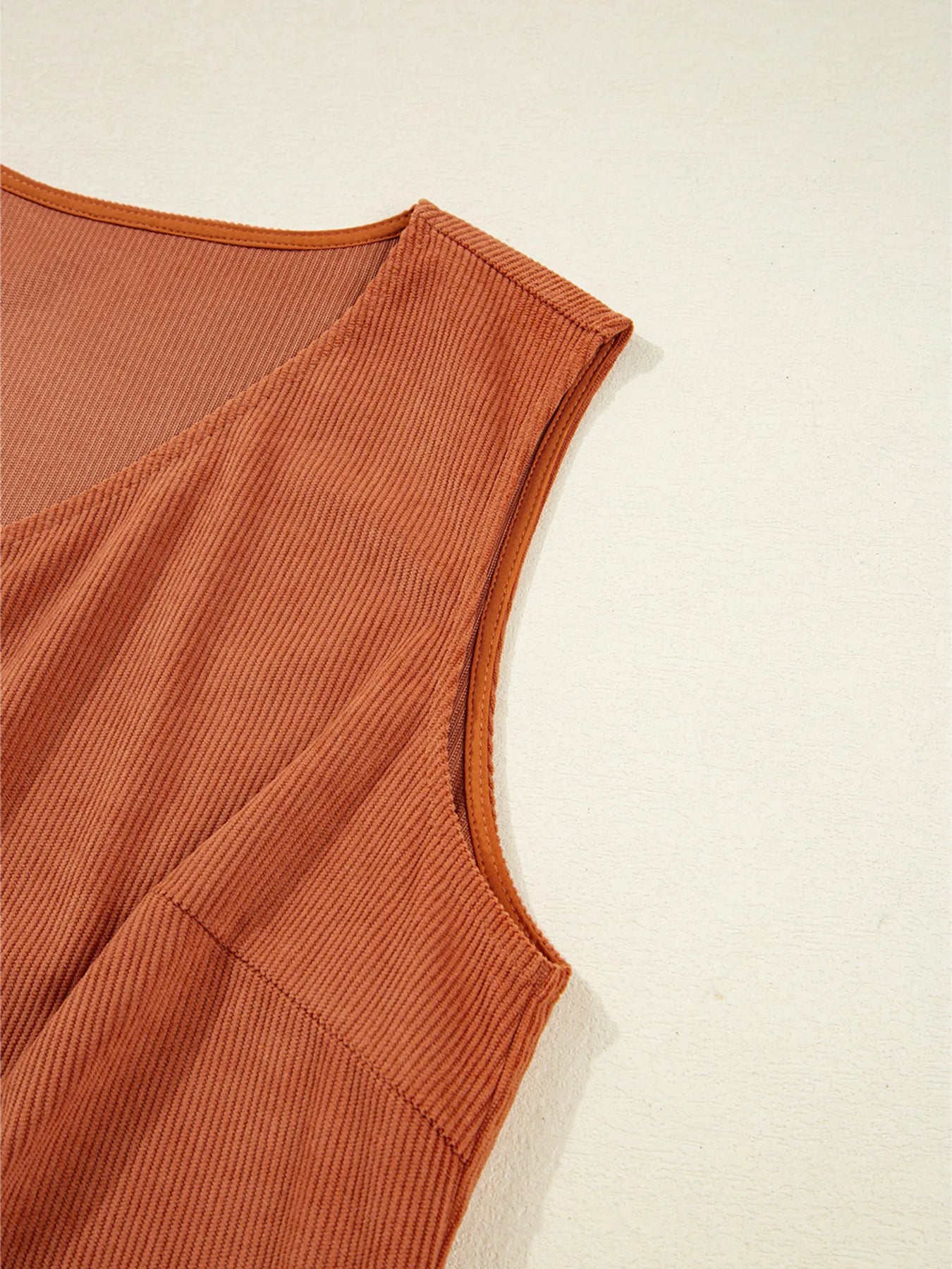 Detail shot of the sleeveless design and armhole of the Corduroy Western Mini Dress With Embroidered Patch Pocket, emphasizing its trendy silhouette and comfortable fit.