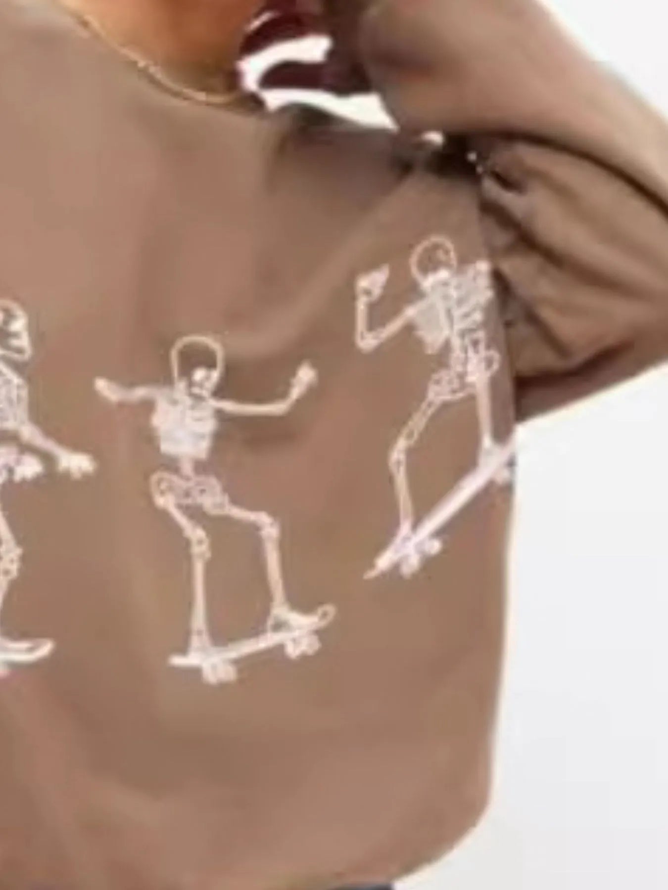 Back view of the Oversized Skeleton Graphic Sweatshirt for Women displaying dynamic skeleton graphics, ideal for a trendy and casual look.
