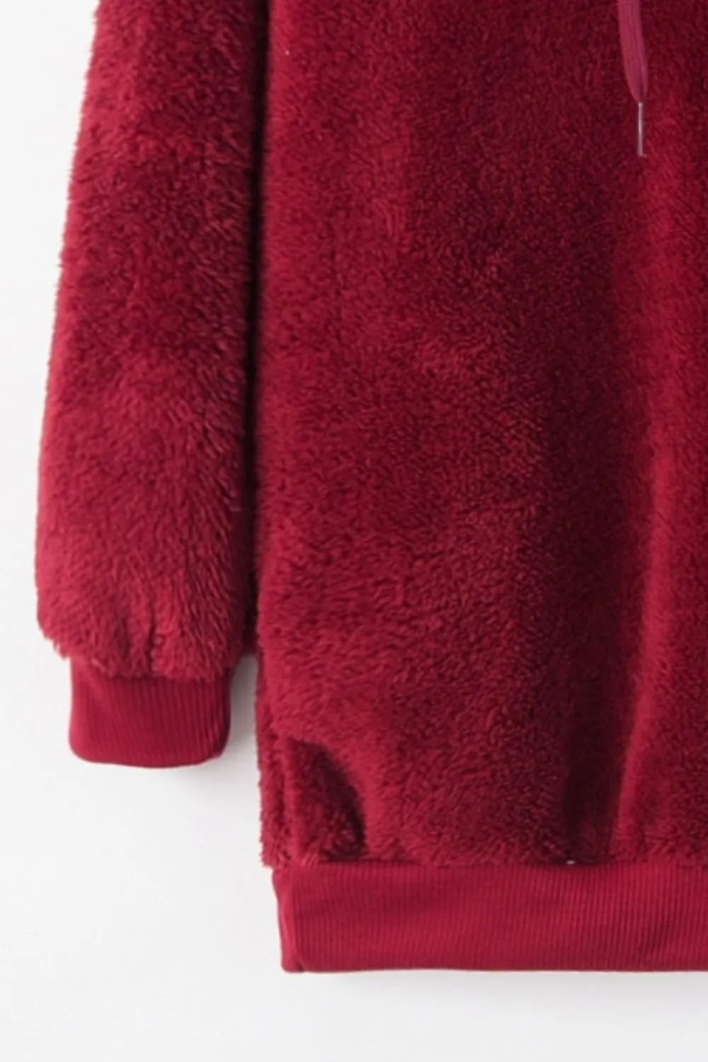 Close-up of the Cozy Full Size Teddy Hoodie with Quarter-Zip and Drawstring in red, highlighting its soft fleece finish.
