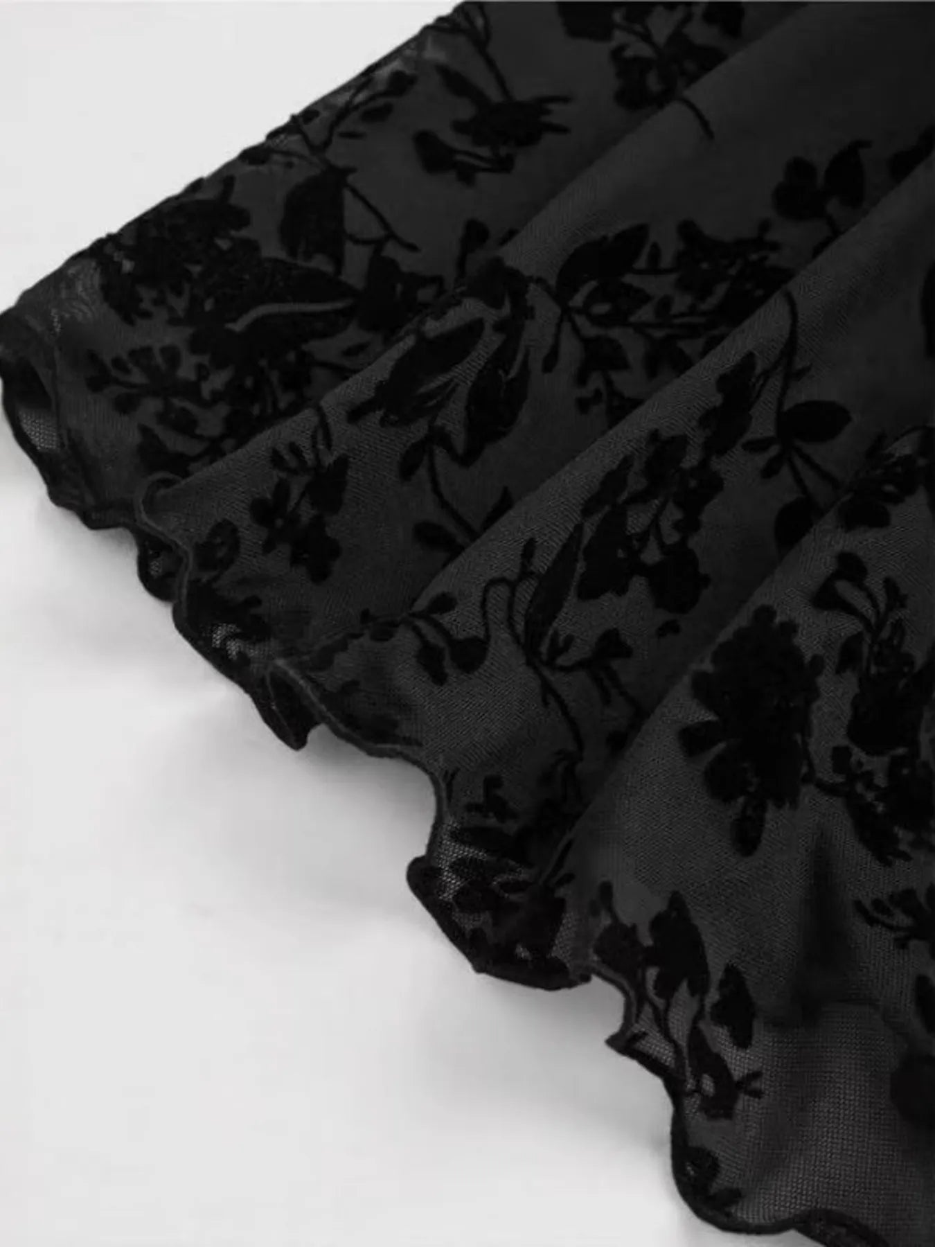 Detailed view of Women's Lace Flare Sleeve Mini Dress with Tied Detail, highlighting the exquisite floral lace trim and texture for a refined look.