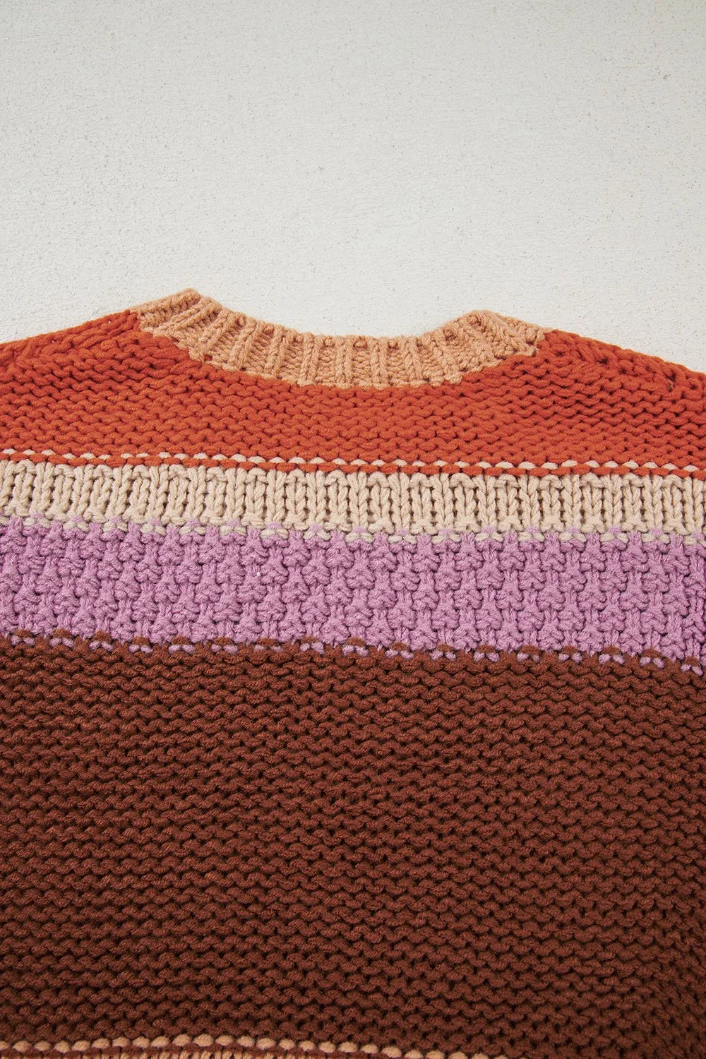 Back view of the Stylish Colorblock Striped Sweater with Round Neck, showcasing a vibrant combination of colors in a textured knit design. Perfect for adding a pop of color to your wardrobe.