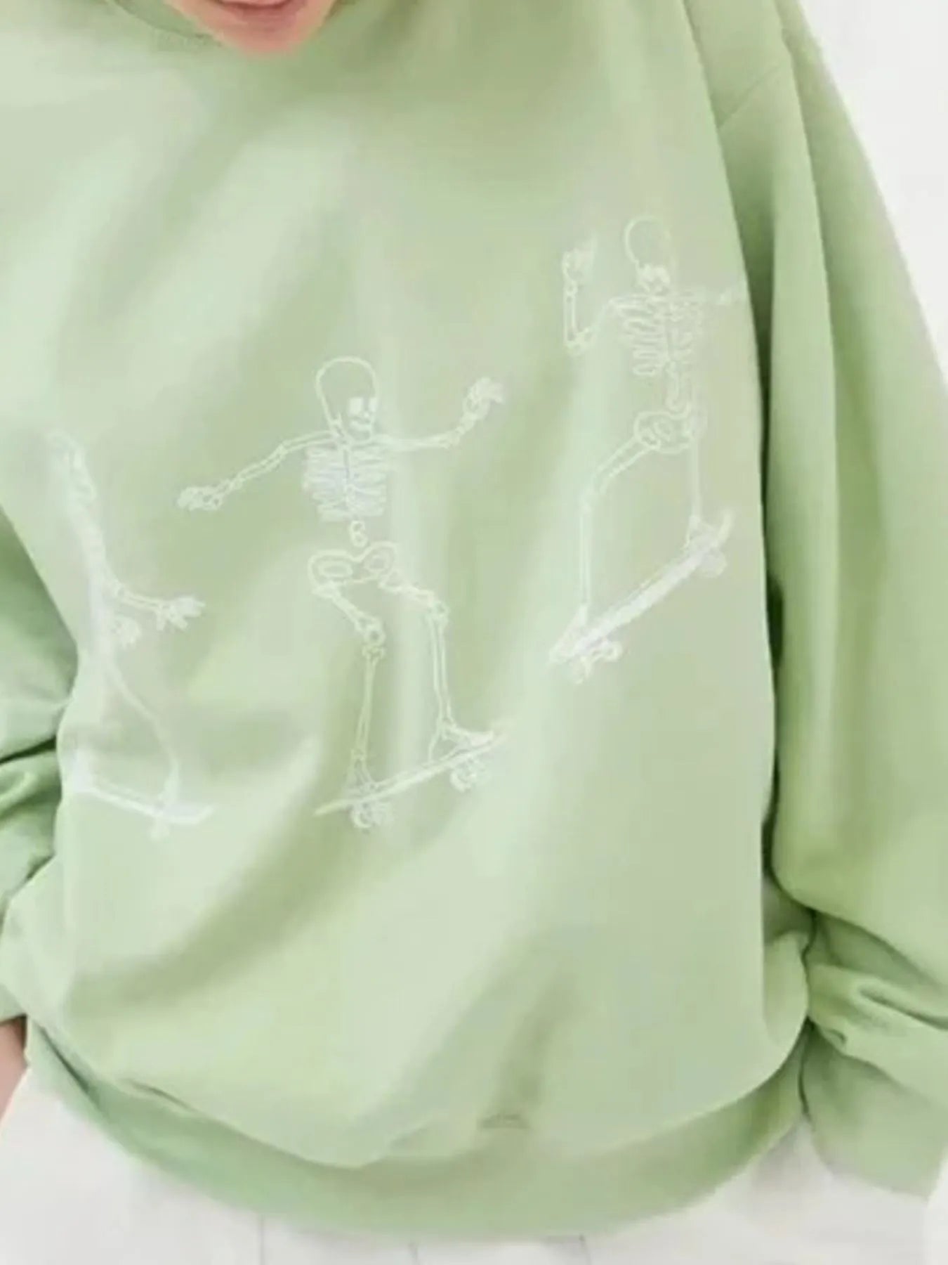Oversized Skeleton Graphic Sweatshirt for Women in a stylish green color, featuring a playful skeleton graphic, ideal for a trendy outfit.