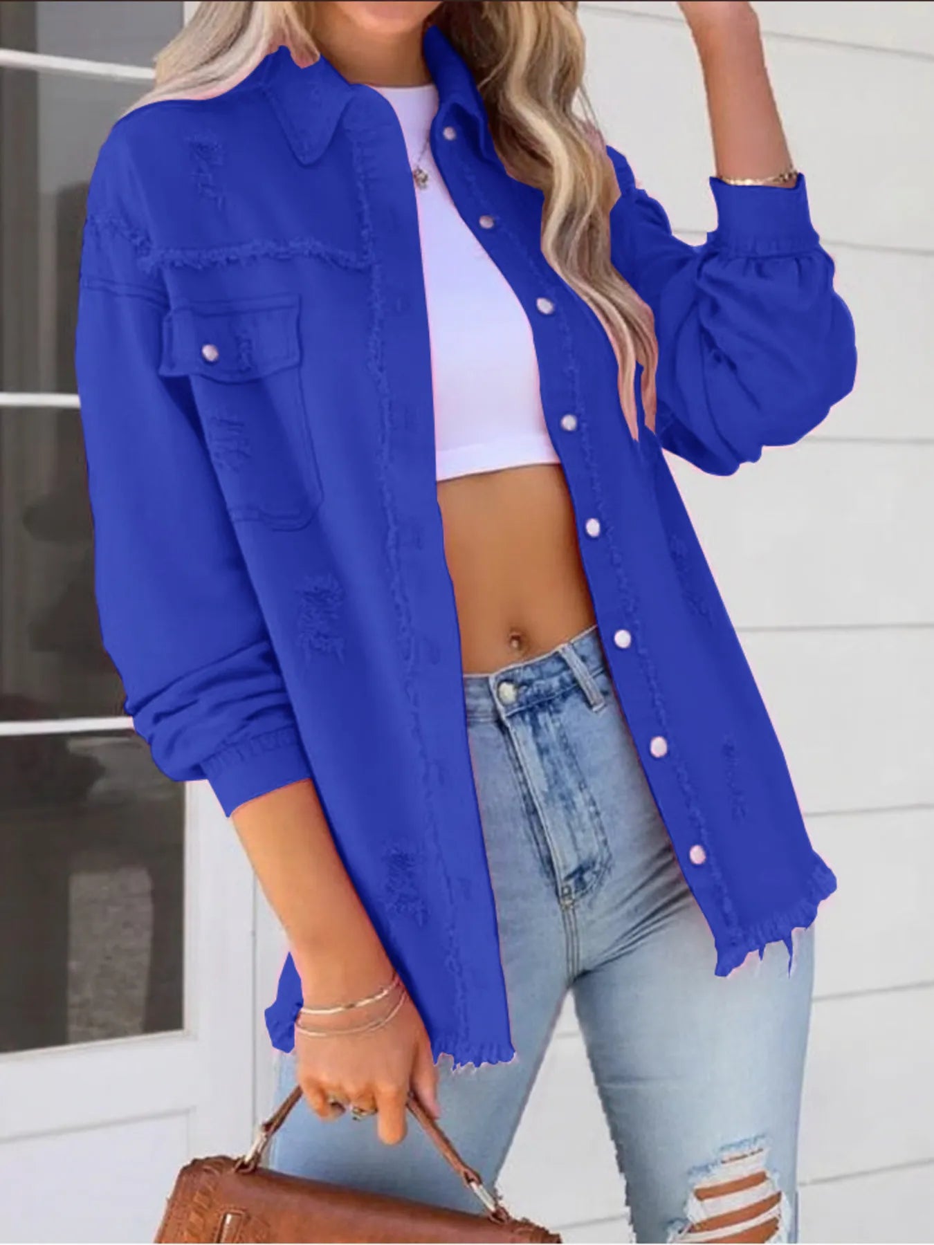 Oversized Distressed Denim Jacket with Frayed Edges and Buttoned Pockets in striking blue, a versatile choice for fashionable casual wear.
