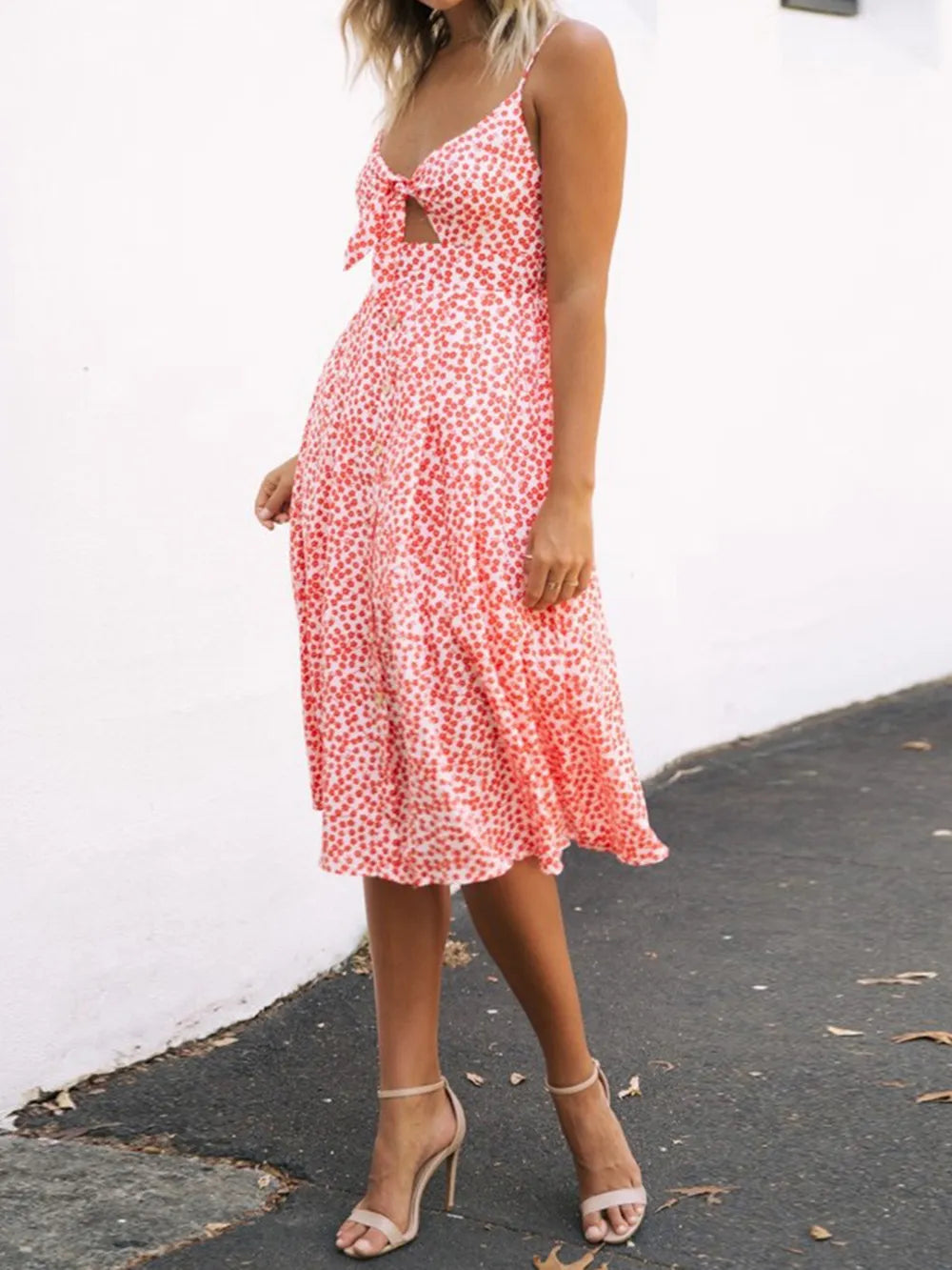 Model wearing a Cutout Smocked Sweetheart Neck Cami Dress with Decorative Button and Opaque Design while walking on a street.