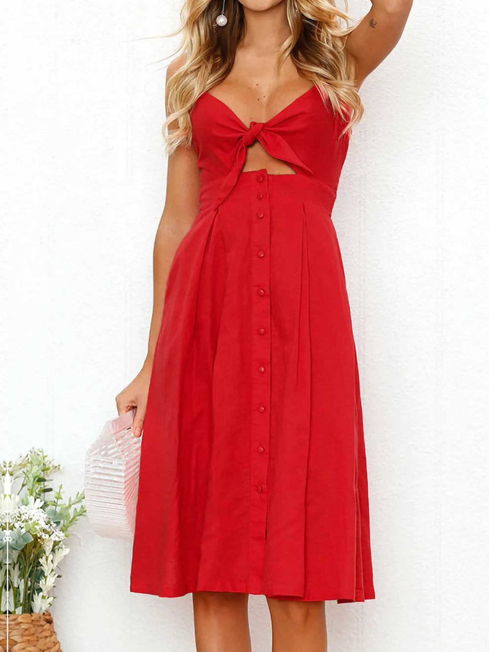 Front view of the vibrant red Cutout Smocked Sweetheart Neck Cami Dress with Decorative Button and Opaque Design, highlighted by a decorative button detail.