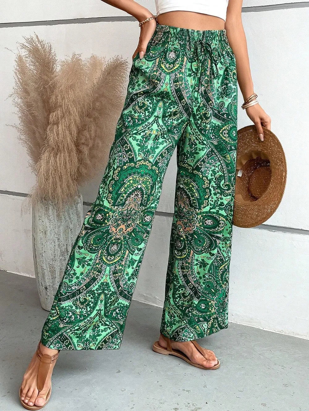 Back view of the Trendy Printed Wide Leg Pants with Tied Detail, featuring an exquisite green paisley print, suitable for fashionable outings and daily wear.