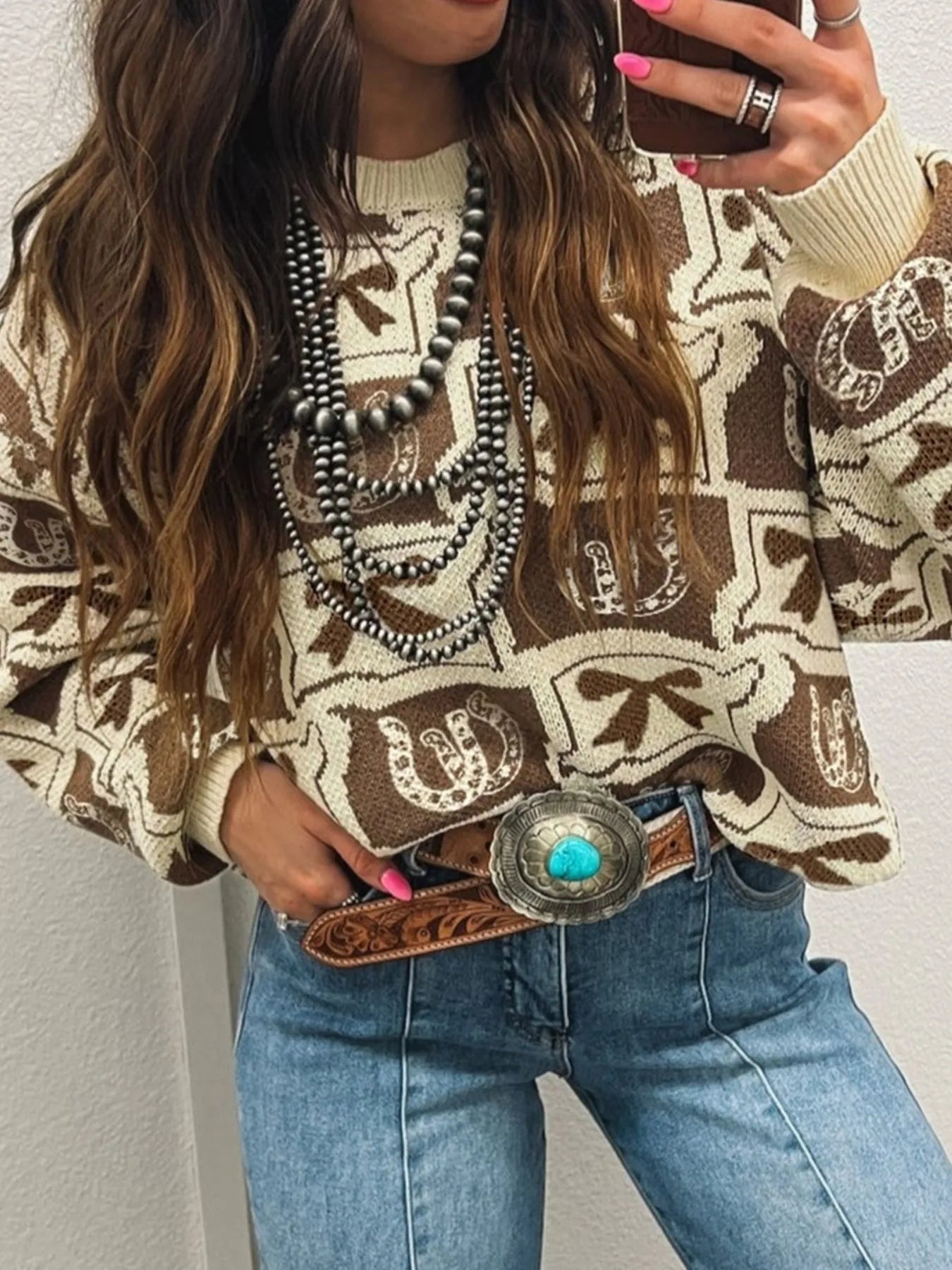 Trendy Graphic Round Neck Long Sleeve Sweater - Soft Viscose Blend with Stretch, showcasing an elegant pattern, worn with slim-fit jeans and accessorized with a silver belt, ideal for a fashionable look.