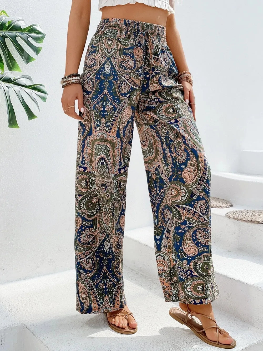 Trendy Printed Wide Leg Pants with Tied Detail displayed on a model in a stylish outfit, featuring a paisley pattern and perfect drape, made of 100% opaque polyester.