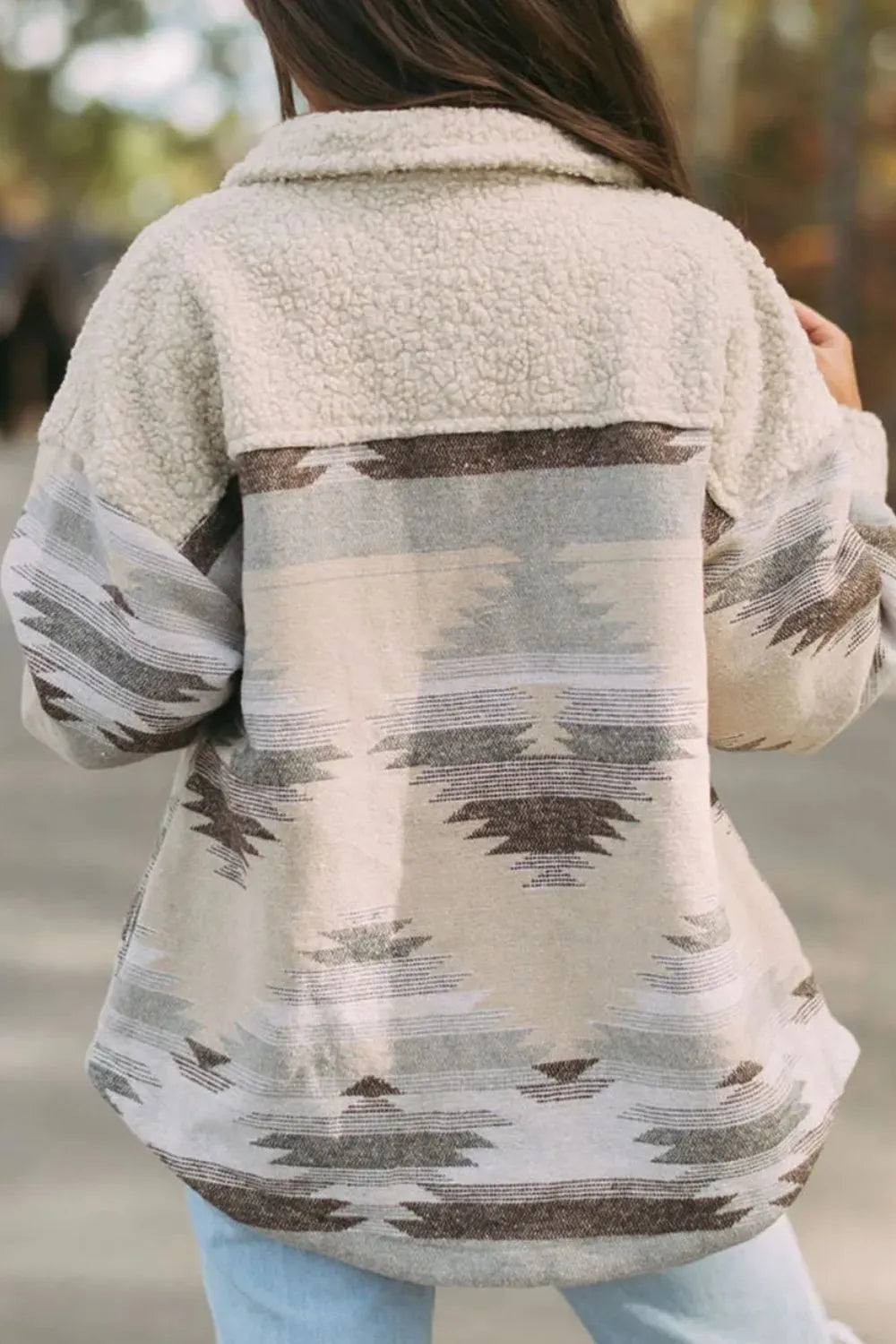Back view of the Trendsi Button Up Long Sleeve Jacket in a light beige design, featuring a soft texture and unique pattern on a casual outing.