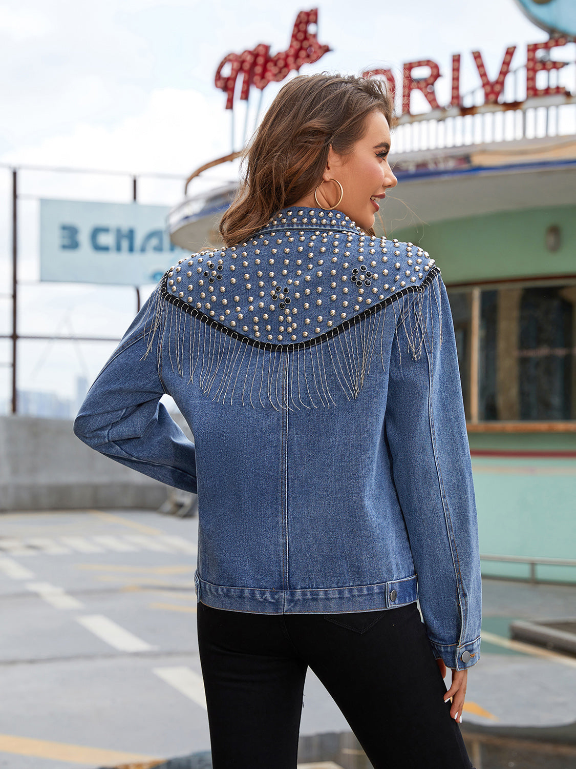 Back view of the Trendsi Studded Fringe Button Down Denim Jacket featuring stud details and fringe design, made from a stylish cotton blend with no stretch.
