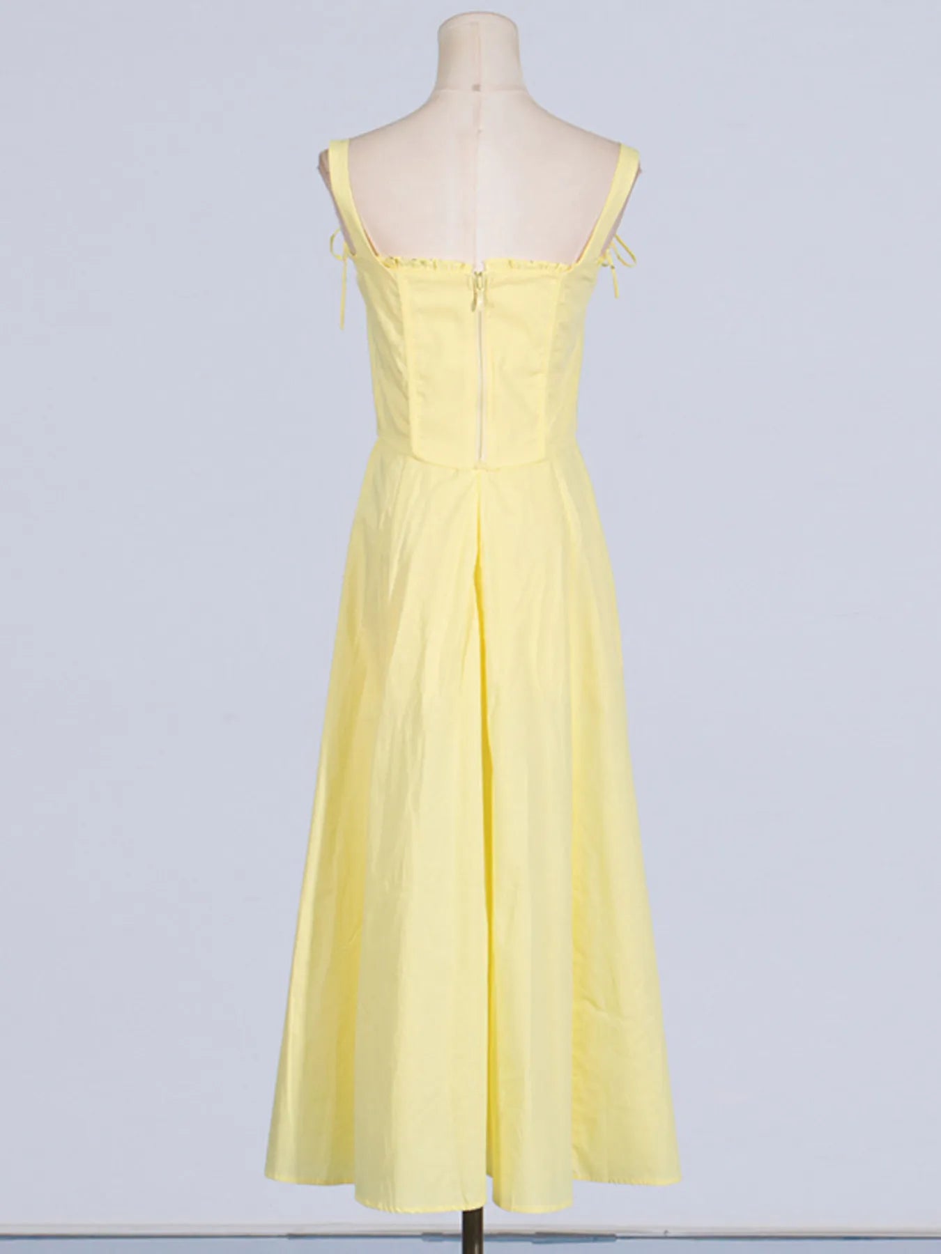 Back view of the Trendy Slit Sleeveless Midi Dress with Zip Back in yellow, highlighting the zip closure and elegant frill details.