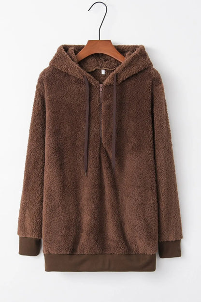 Cozy Full Size Teddy Hoodie with Quarter-Zip and Drawstring, Opaque & Slightly Stretchy, 100% Polyester, displayed on a hanger showcasing its soft, fluffy texture and design.