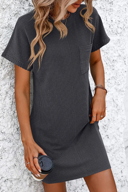 Close-up of Mandy Ribbed Striped Mini Tee Dress with Pockets in black, emphasizing its ribbed texture and stylish features.