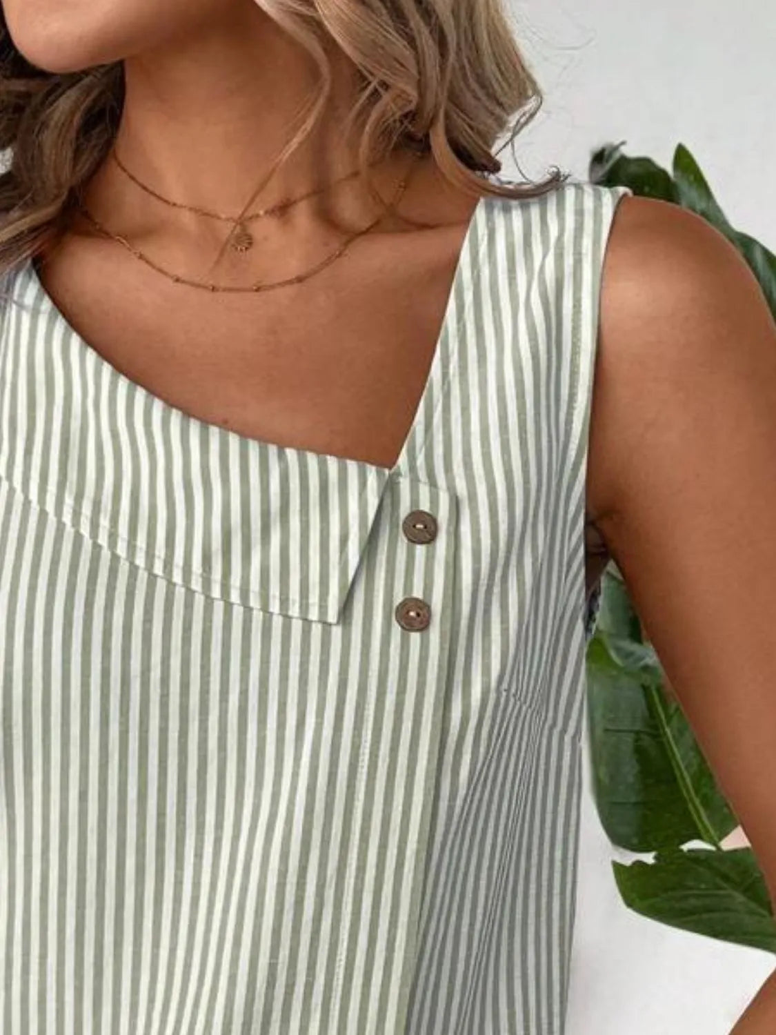 Close-up of the button detail on the Asymmetrical Striped Tank with Decorative Buttons for Women, emphasizing its unique, elegant design.