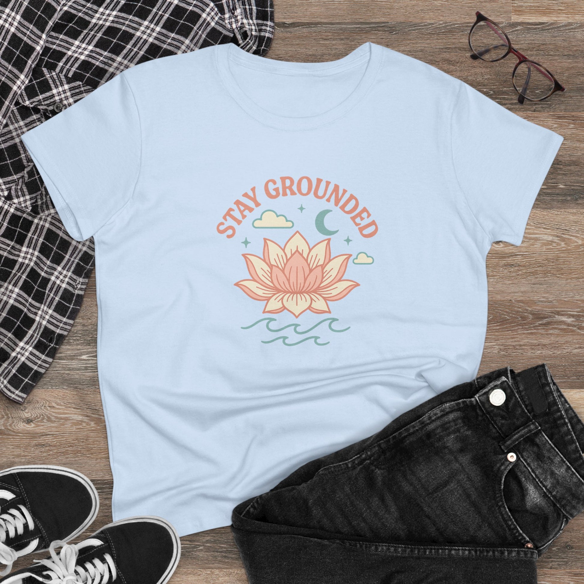 Stay Grounded Spiritual Tee featuring a floral lotus design on a light blue crop top, perfect for festivals and casual outings.