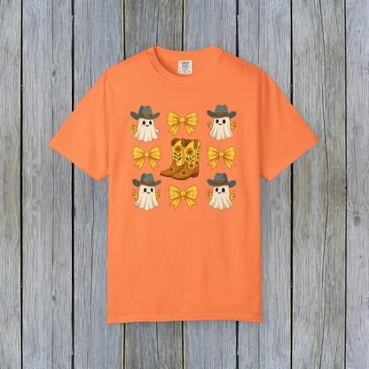 Cute Halloween T-Shirt in vibrant orange with playful ghost graphics, cowboy boots, and bows, representing unisex fall fashion made from eco-friendly fabric.