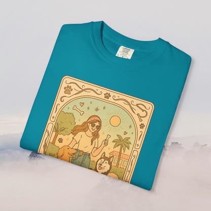 Animal Lover Tarot Tee in vibrant turquoise featuring an illustration of a woman enjoying time with her dogs in the sun, 100% soft cotton material, available in sizes S to 4XL.