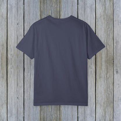 Back view of the Unisex Garment-Dyed Lake Rules Tee - Soft Vintage Fabric, Sizes S to 4XL, ideal for outdoor adventures, displayed against a weathered wooden texture.