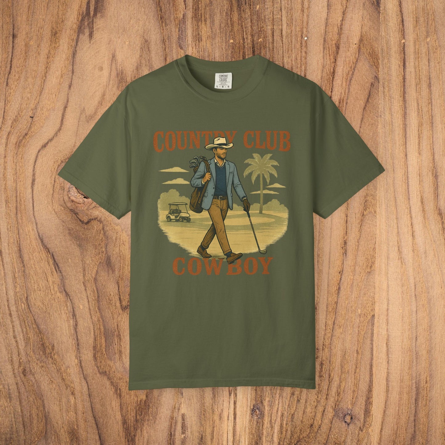 Country Club Cowboy Graphic Tee in olive green featuring a stylish cowboy carrying a golf bag, ideal for casual outings.