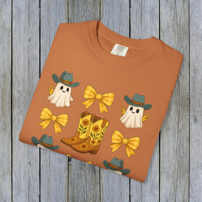 Cute Halloween T-Shirt in warm orange color, adorned with cheerful ghosts and cowboy boots, made from sustainable materials for autumn styling.