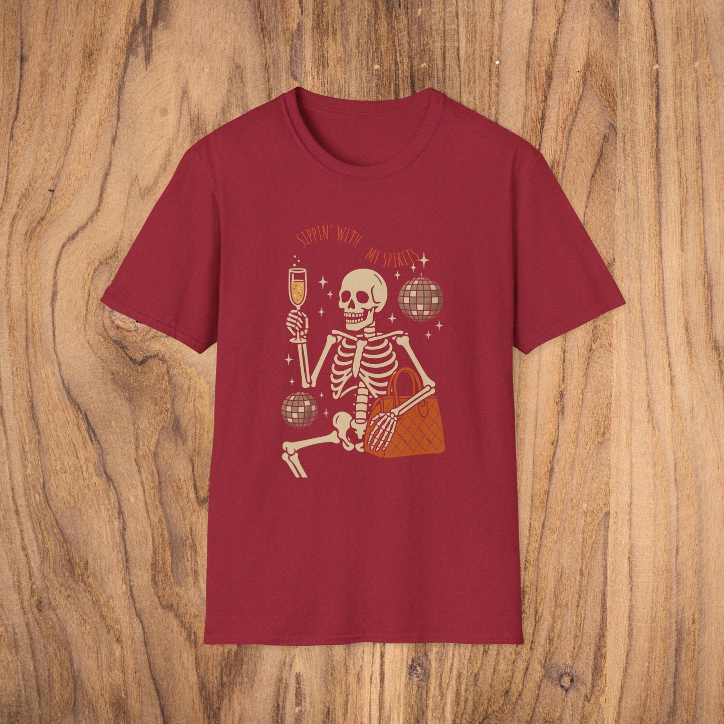 Spooky Spirits Graphic Tee in red displaying a whimsical skeleton sipping a drink, perfect for Halloween gatherings.