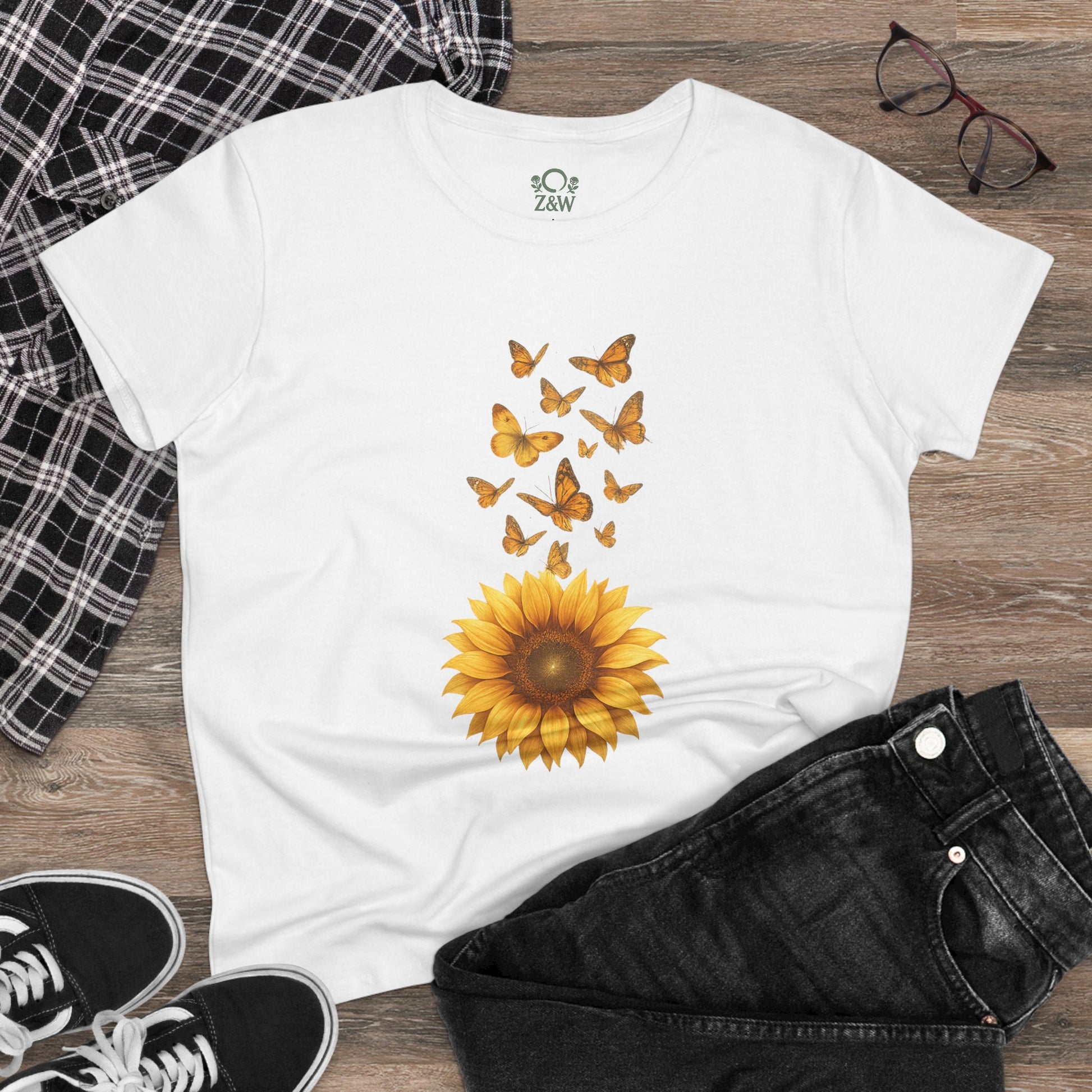 Casual setting showcasing the Sunflower & Butterflies Cotton Tee for Women, paired with jeans and plaid for a trendy outfit that highlights nature-inspired designs.