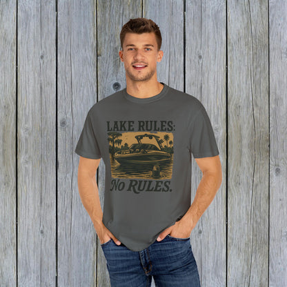 Model wearing a Unisex Garment-Dyed Lake Rules Tee in gray, showcasing a vintage boat graphic and the phrase 'LAKE RULES: No RULES.' Ideal for lake lovers and outdoor activities.