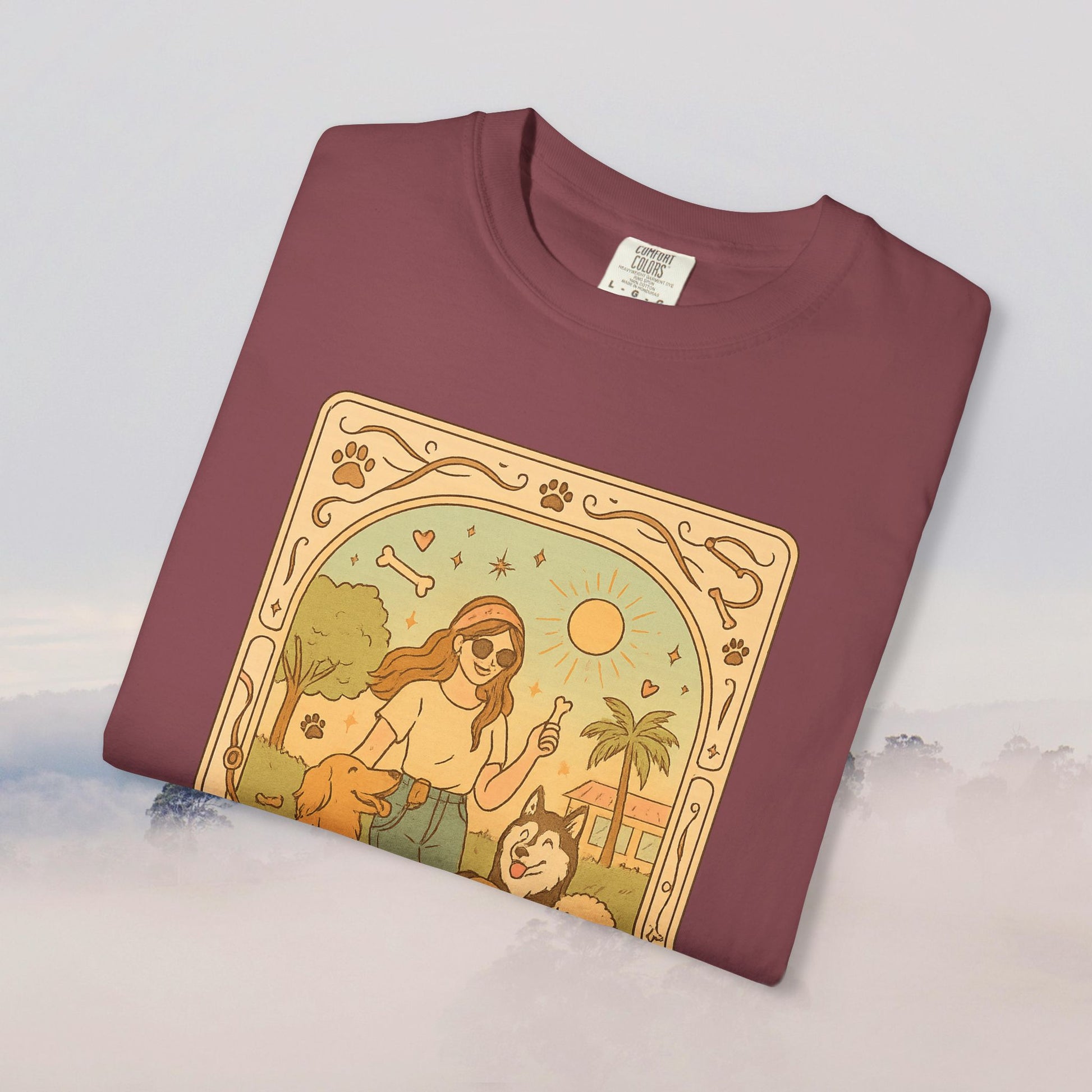 Animal Lover Tarot Tee in a rich maroon color, featuring a delightful graphic of a person surrounded by dogs and nature, made from sustainable 100% cotton.