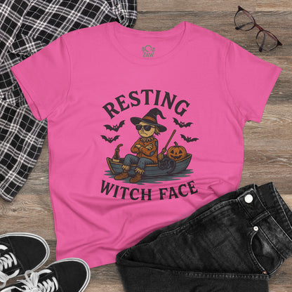 Resting Witch Face Halloween T-Shirt for Women on a flat lay with jeans and glasses. The pink tee features a creative design of a witch, making it a great choice for party attire or gifts.