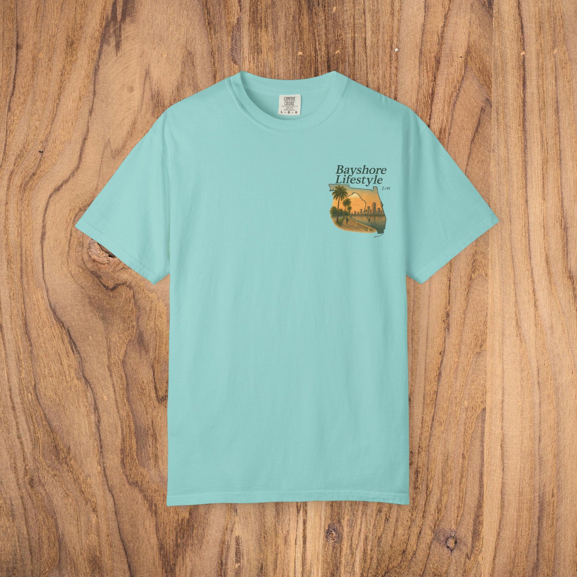 Bayshore Lifestyle Tee - Front view of a light blue 100% cotton t-shirt featuring a vibrant graphic design, perfect for casual wear.