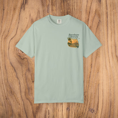 Bayshore Lifestyle Tee in light mint color, designed with a vibrant palm tree motif, crafted from breathable 100% cotton for comfort.