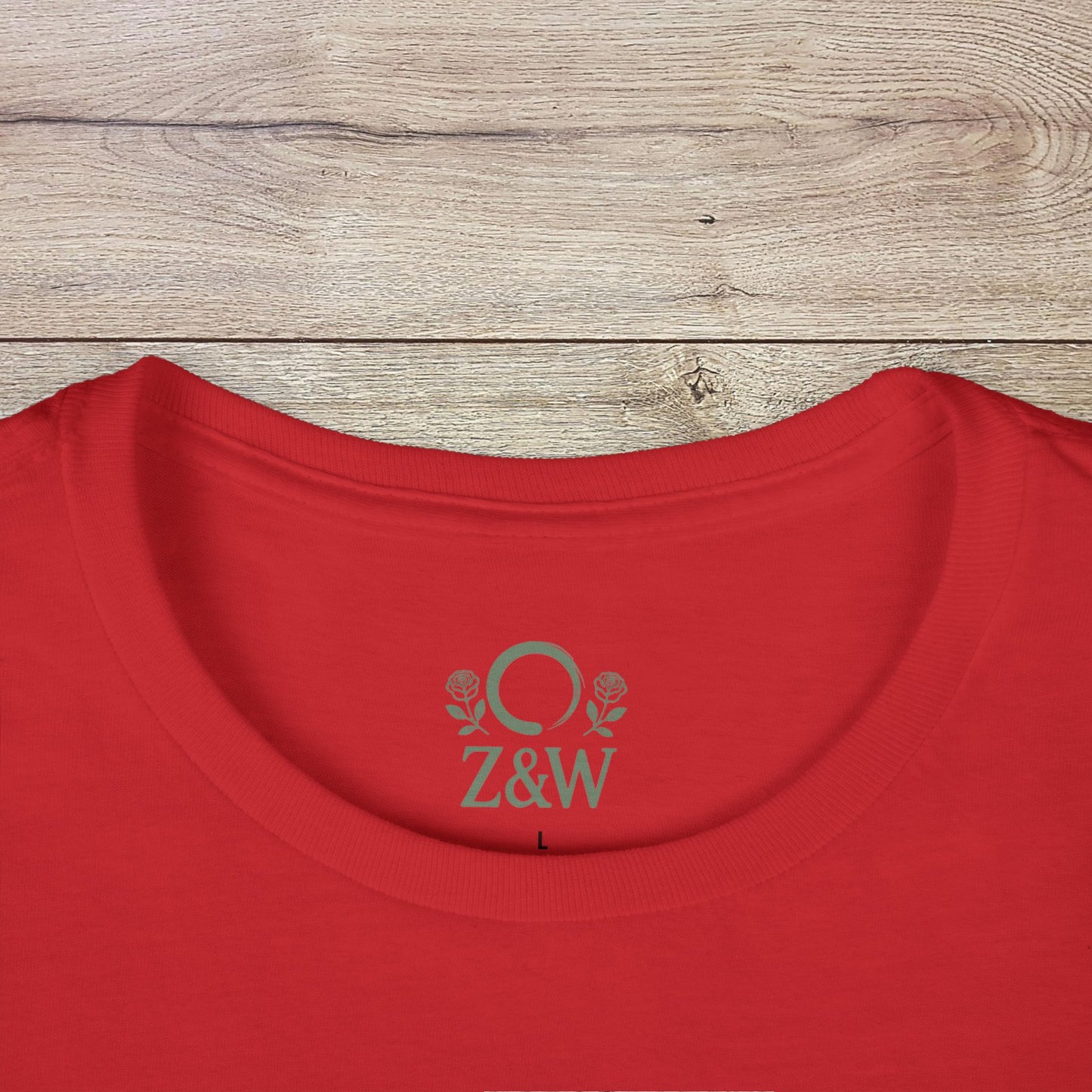 Close-up of the neckline of a red Halloween Family T-Shirt - Raising Little Monsters Cute Kids Tee for Parties & Costumes with a ribbed collar and logo detail.