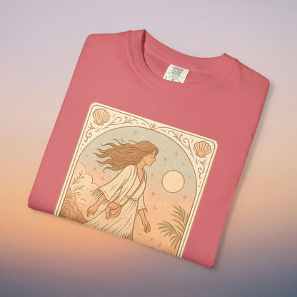 Wanderer Tarot Graphic Tee in vibrant coral pink, displaying a charming design of a woman moving gracefully through nature, made from ethically crafted 100% cotton and available in sizes S to 4XL.