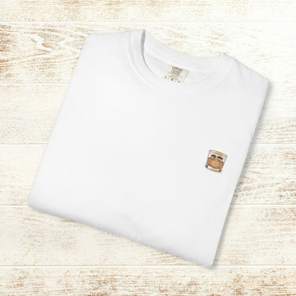Front view of the Rodeo On The Rocks Tee folded neatly, displaying a unique chest graphic of a drink; crafted in durable and soft fabric.