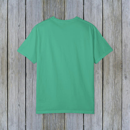 Back view of Unisex Garment-Dyed Lake Rules Tee in vibrant green on a weathered wooden background, showcasing the soft vintage fabric ideal for outdoor activities.