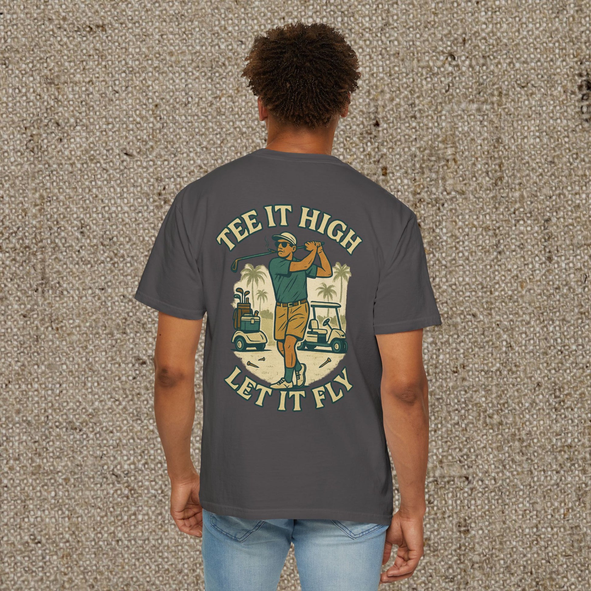 Tee It High Let It Fly Graphic Tee showing a golfer on the back, modeled by a man; your go-to shirt for golfing and casual outings.