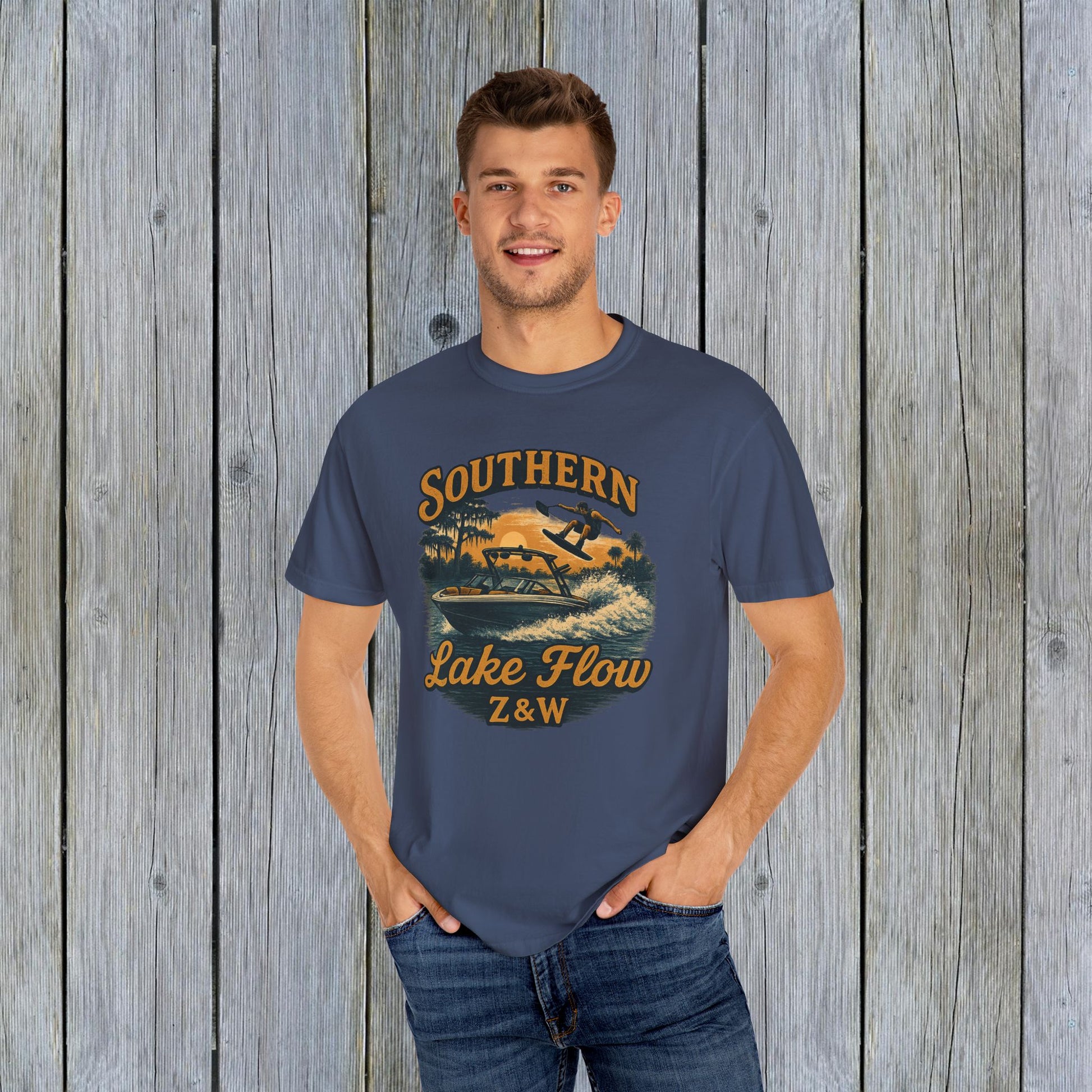 Model wearing the Southern Lake Flow T-Shirt in navy blue, featuring a stylish water sports graphic, ideal for outdoor enthusiasts and made from sustainable materials.