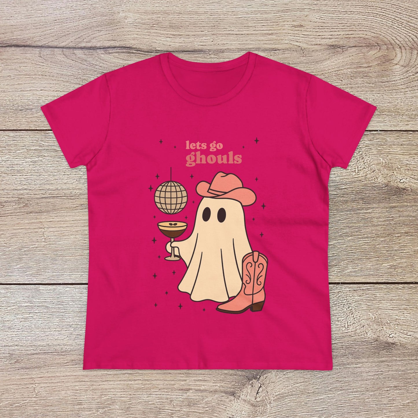 Let's Go Ghouls Tee in vibrant pink with a playful ghost character in a cowboy hat, ideal for Halloween parties and casual wear. Made from 100% cotton for a comfortable fit.