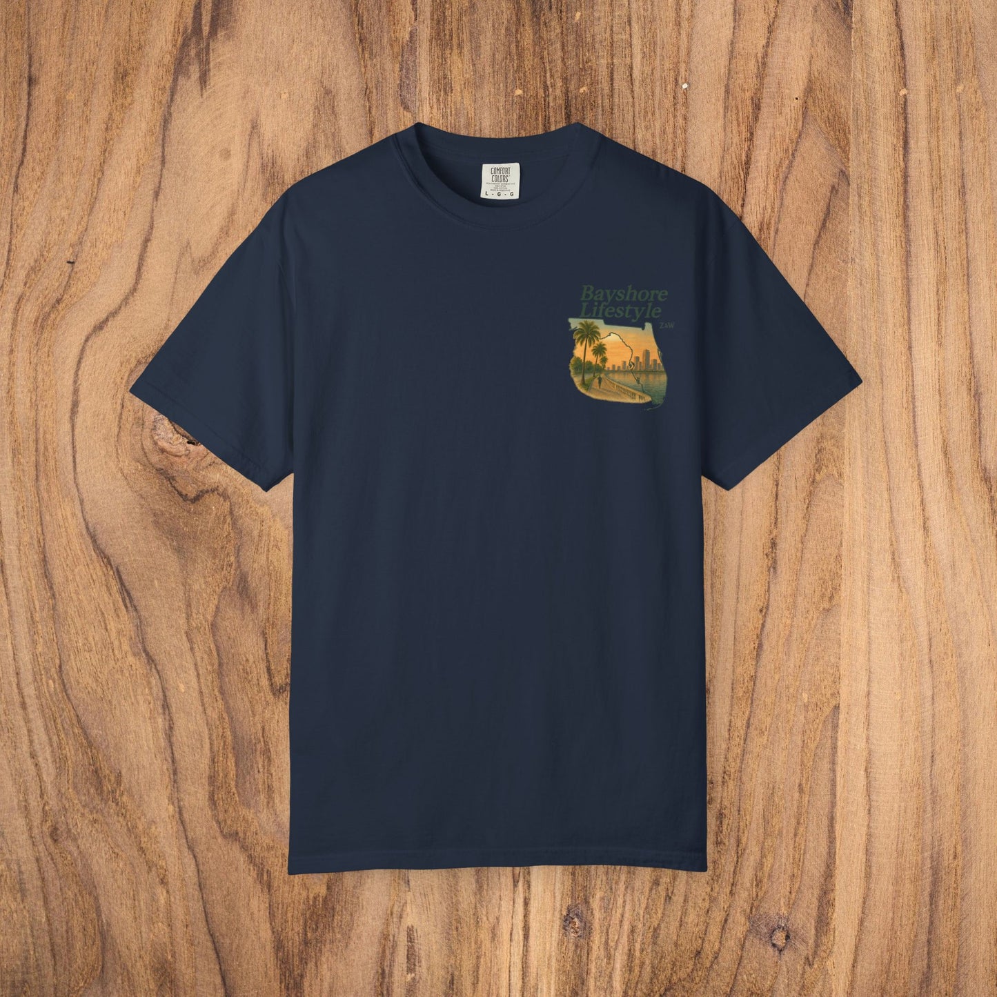 Bayshore Lifestyle Tee in navy blue, featuring a vibrant palm tree graphic. This tee is made from 100% cotton lightweight fabric with a comfortable ribbed neck, available in sizes XS-5XL.