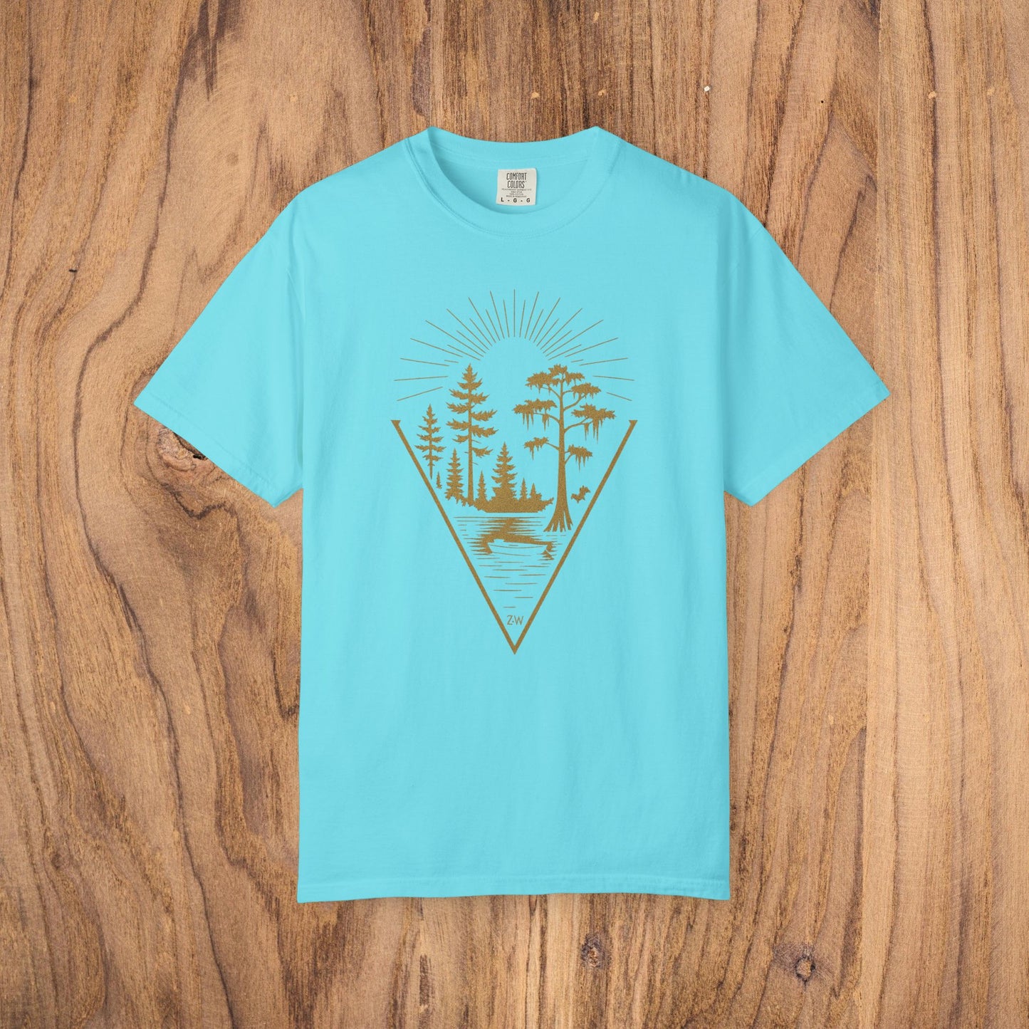 Nature Outdoor Vibes Tee in light blue, showcasing a tranquil nature scene, crafted from soft and sustainable 100% US cotton, ideal for outdoor enthusiasts.