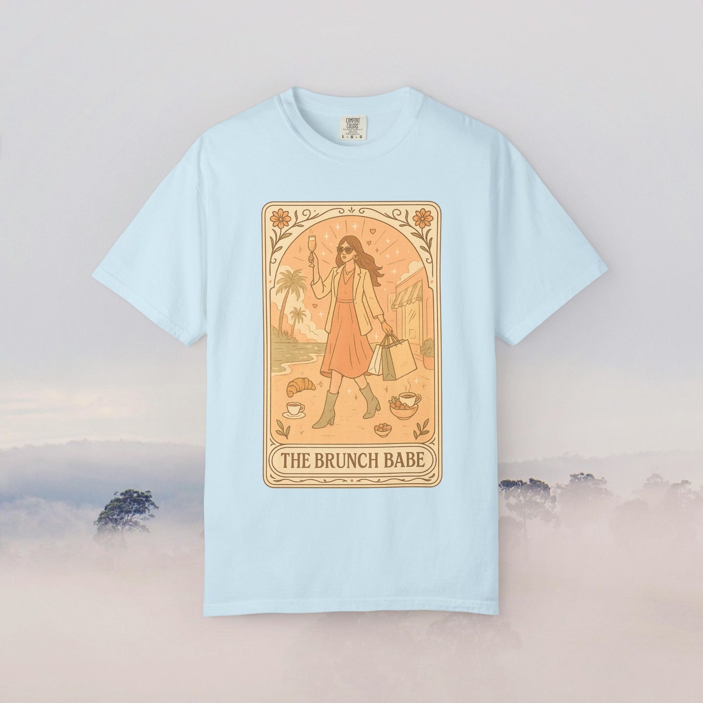 Brunch Babe Tarot Graphic Tee presented in a light blue hue, highlighting its stylish graphic and comfortable fit, ideal for brunch outings.