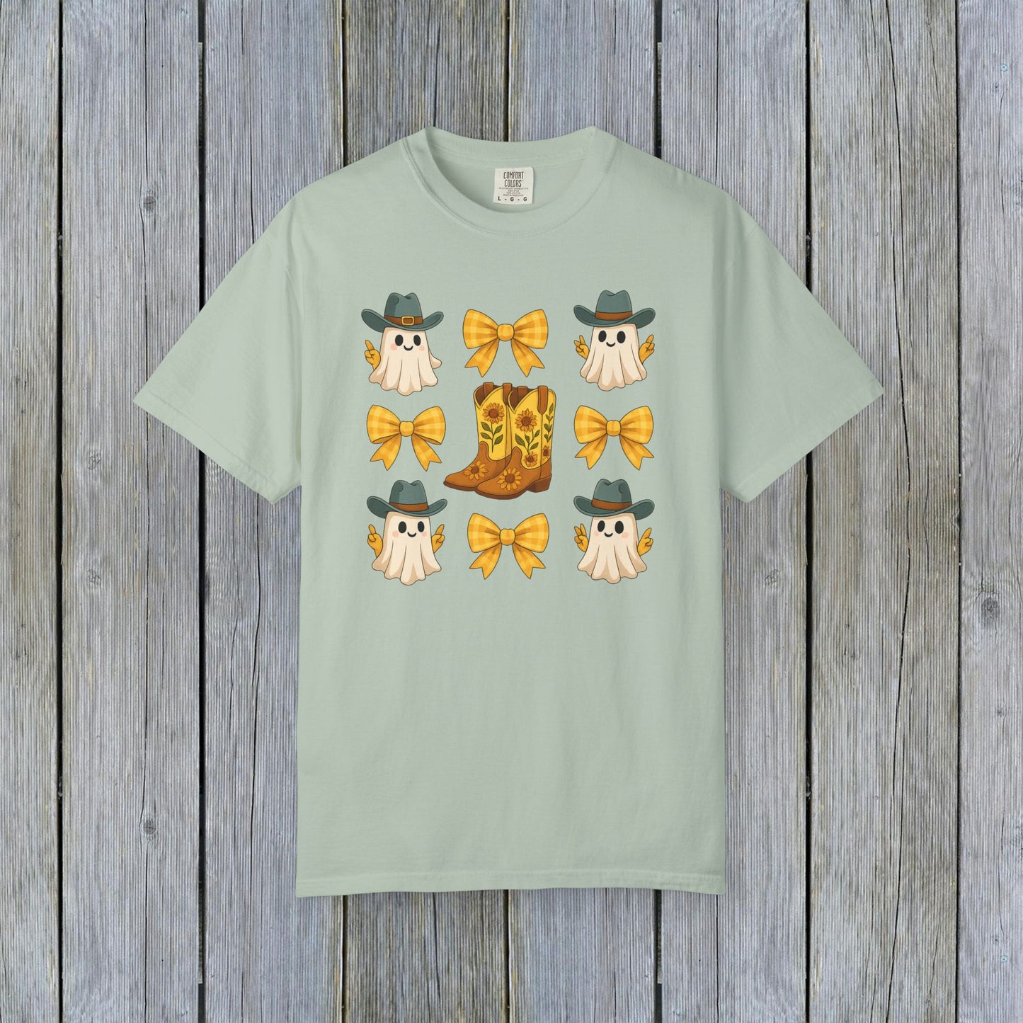 Cute Halloween T-Shirt featuring playful ghosts in cowboy hats and cowboy boots adorned with yellow bows, perfect for unisex fall fashion, made from eco-friendly fabric.