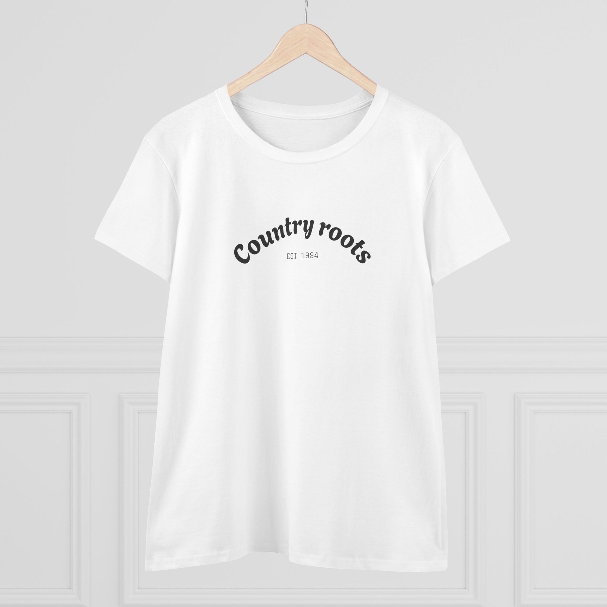 Front view of Country Roots Cowgirl Tee hanging, highlighting the elegant 'Country roots EST. 1994' logo against a clean backdrop.
