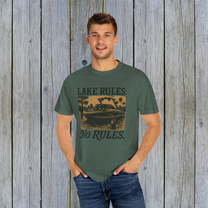 Casual wear featuring a man in a green Unisex Garment-Dyed Lake Rules Tee, highlighting the boat design, ideal for summer outings.