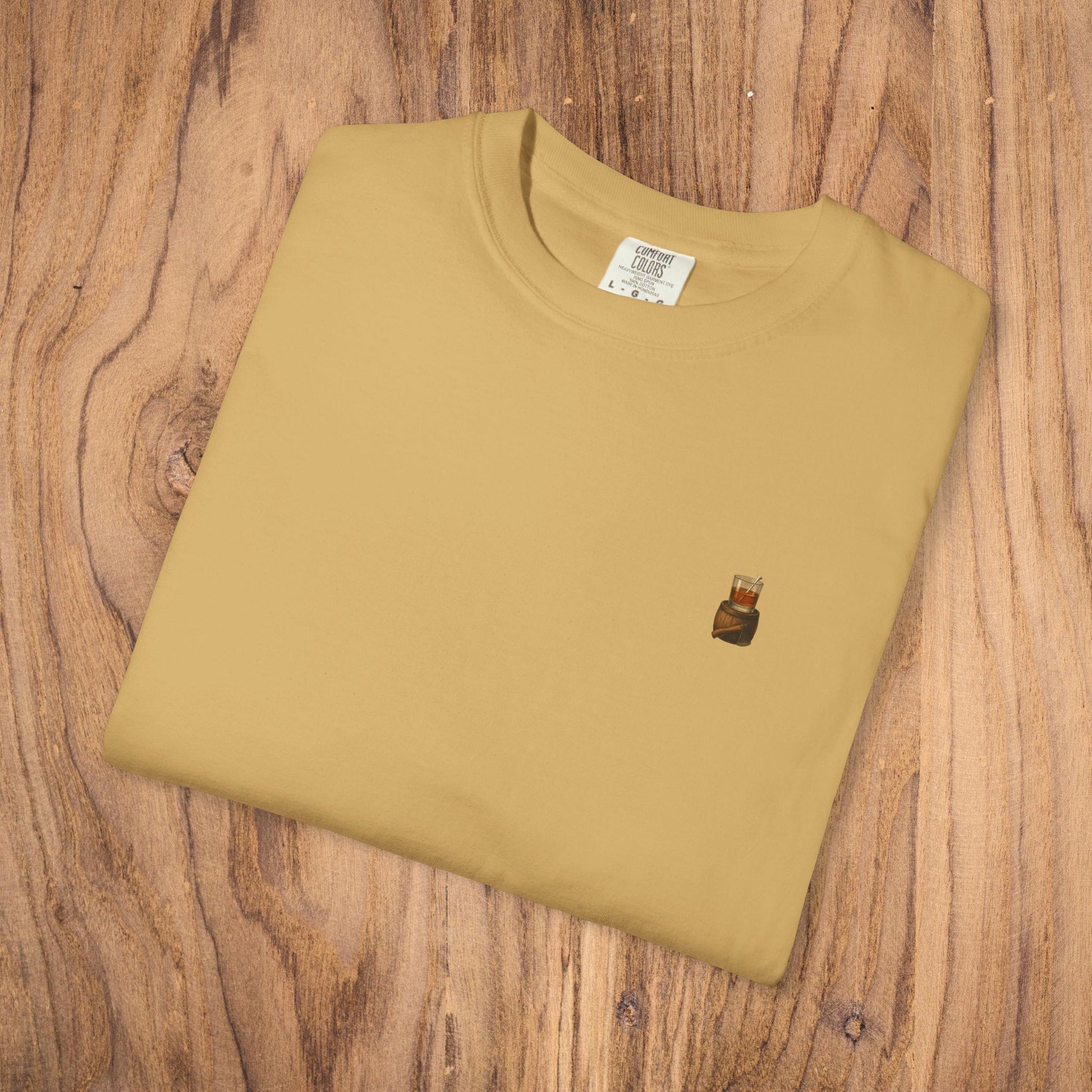 Premium Southern Made T-Shirt neatly folded on a wooden surface, featuring a stylish logo in a mustard yellow color.