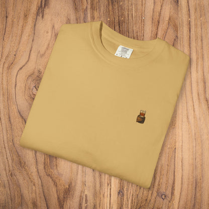 Premium Southern Made T-Shirt neatly folded on a wooden surface, featuring a stylish logo in a mustard yellow color.