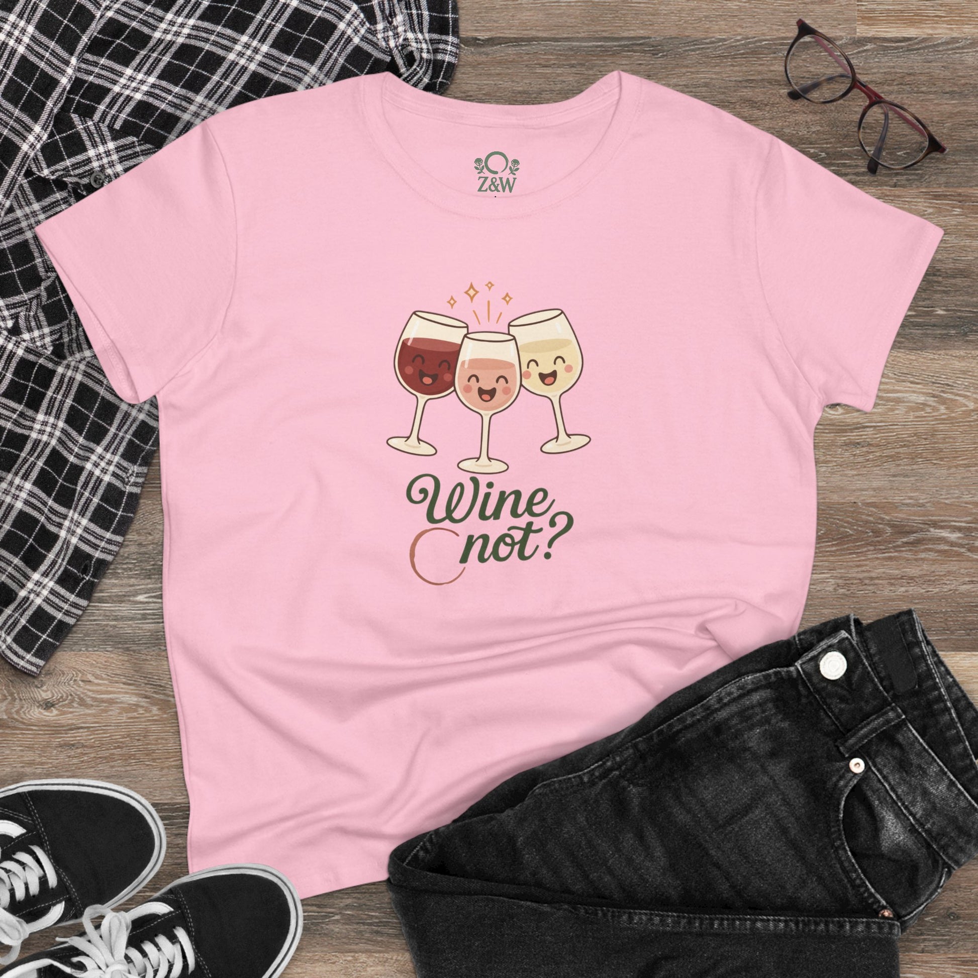 Lifestyle shot of the Wine Not Tee in pink, styled with black jeans and plaid, highlighting the comfortable fit and trendy design.